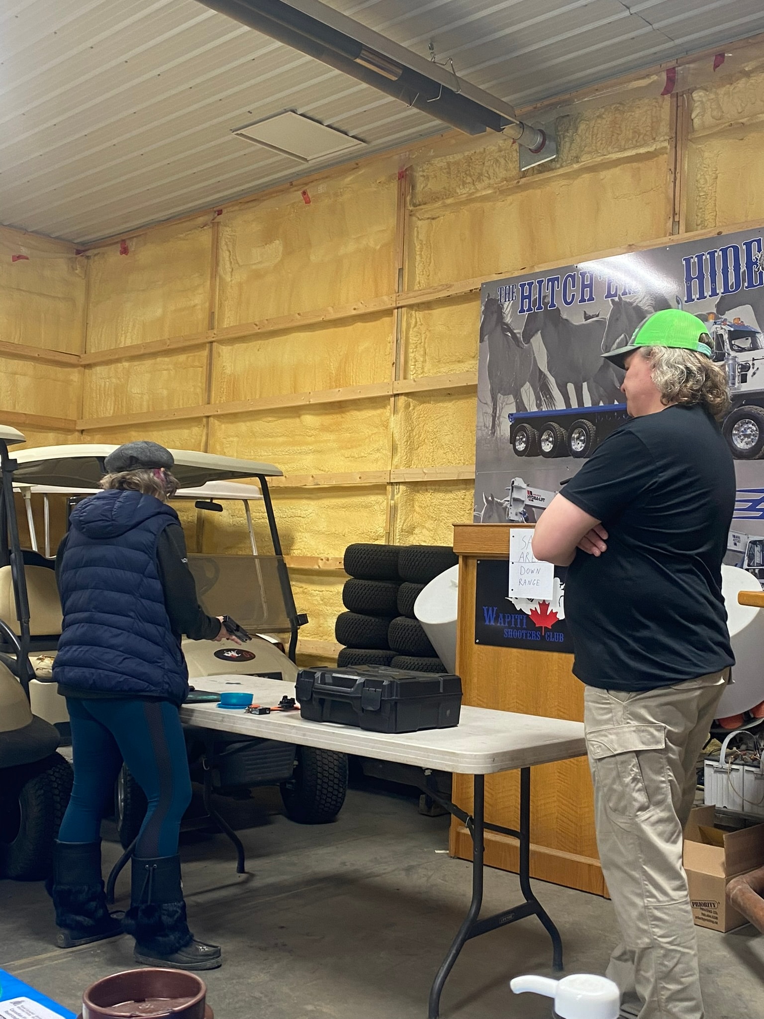 Instructor demonstrating safe firearms handling indoors